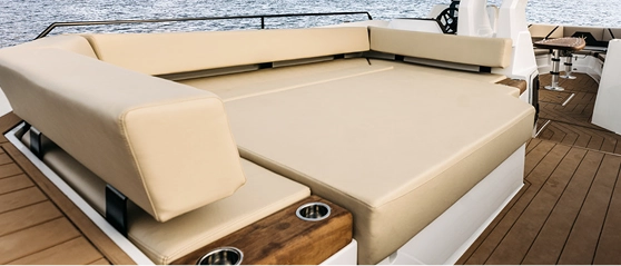 Aft deck sun pad with beige cushions and teak flooring on the Navy Blue Raptor