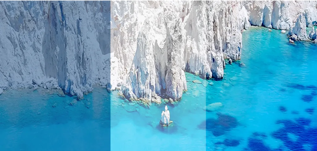 Kleftiko sea caves and natural rock arch over crystal-clear water in Milos