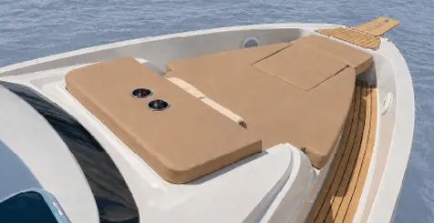 Ryck bow lounge with cushioned sun pad and teak deck, Navy Blue Private Cruise in Milos