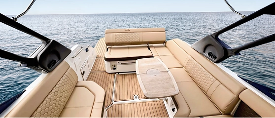 Navy Blue Sea Ray teak deck with cushioned lounge seating and fold-out dining table
