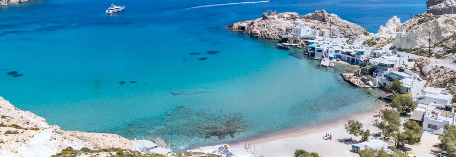 Turquoise bay and traditional fishing village in Milos.