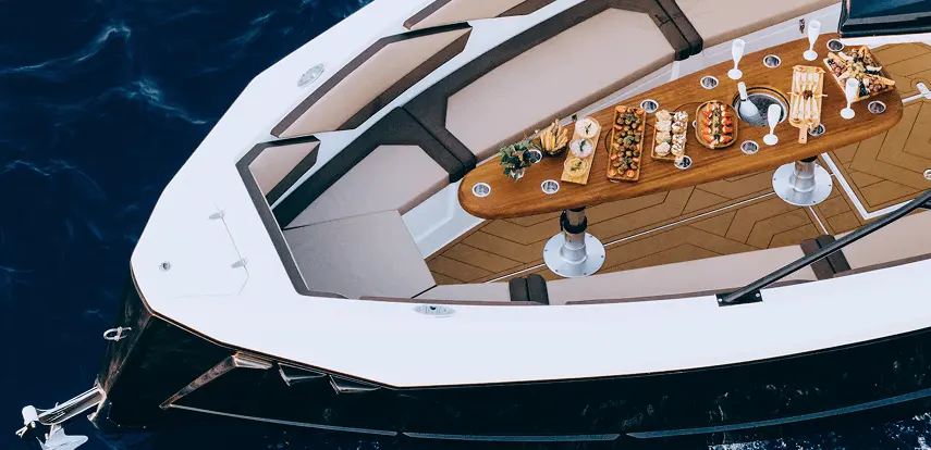 Bow dining setup with Mediterranean platters and champagne on the Navy Blue Raptor
