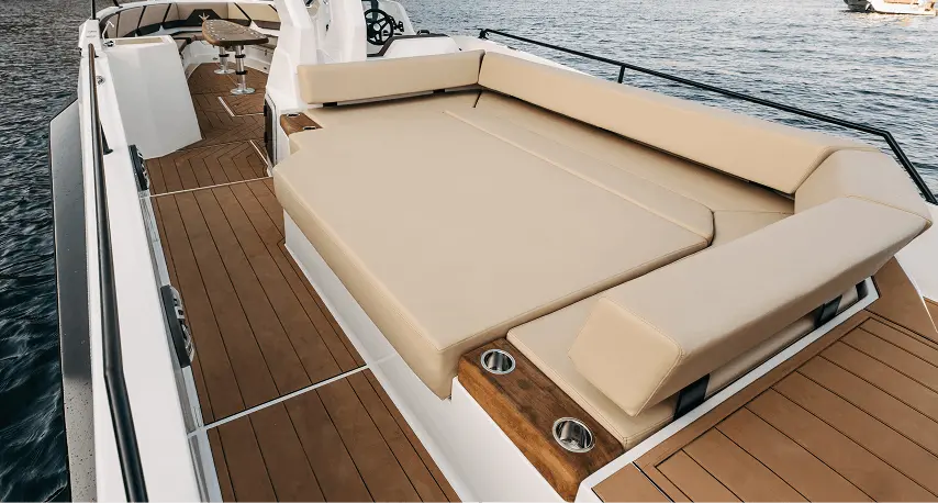 Stern sun pad with plush seating and teak walkways on the Navy Blue Raptor