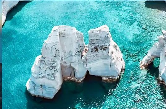 Klima, the traditional fishing village on Milos with colorful syrmata boat houses along the shoreline, by Navy Blue