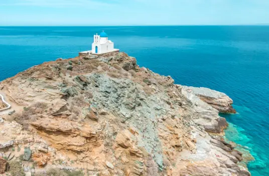 The Seven Martyrs chapel on a rocky headland above the Aegean in Kastro, Sifnos, by Navy Blue.