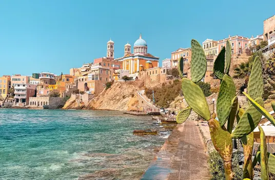Ano Syros rising above the waterfront of Ermoupoli, with church towers on the hilltop
