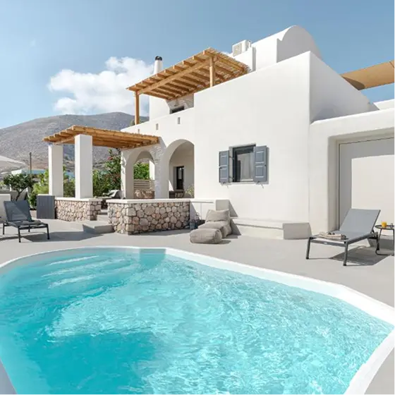 Whitewashed Cycladic villa with a private pool, sun loungers, and a shaded pergola terrace
