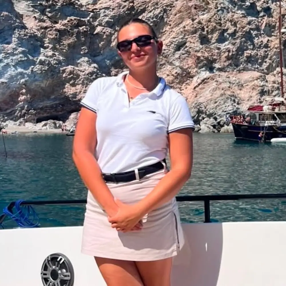 Anastasia Christou, Navy Blue host, attending to guests during a cruise in the Cyclades