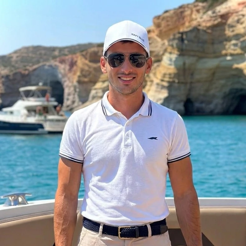 Dimitrios Gkinis, Navy Blue captain, at the helm during a cruise around Milos in the Cyclades