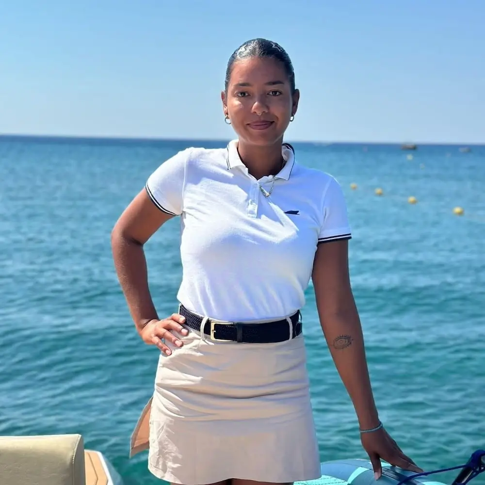 Tressia Billon, Navy Blue host, serving guests during a cruise in the Cyclades